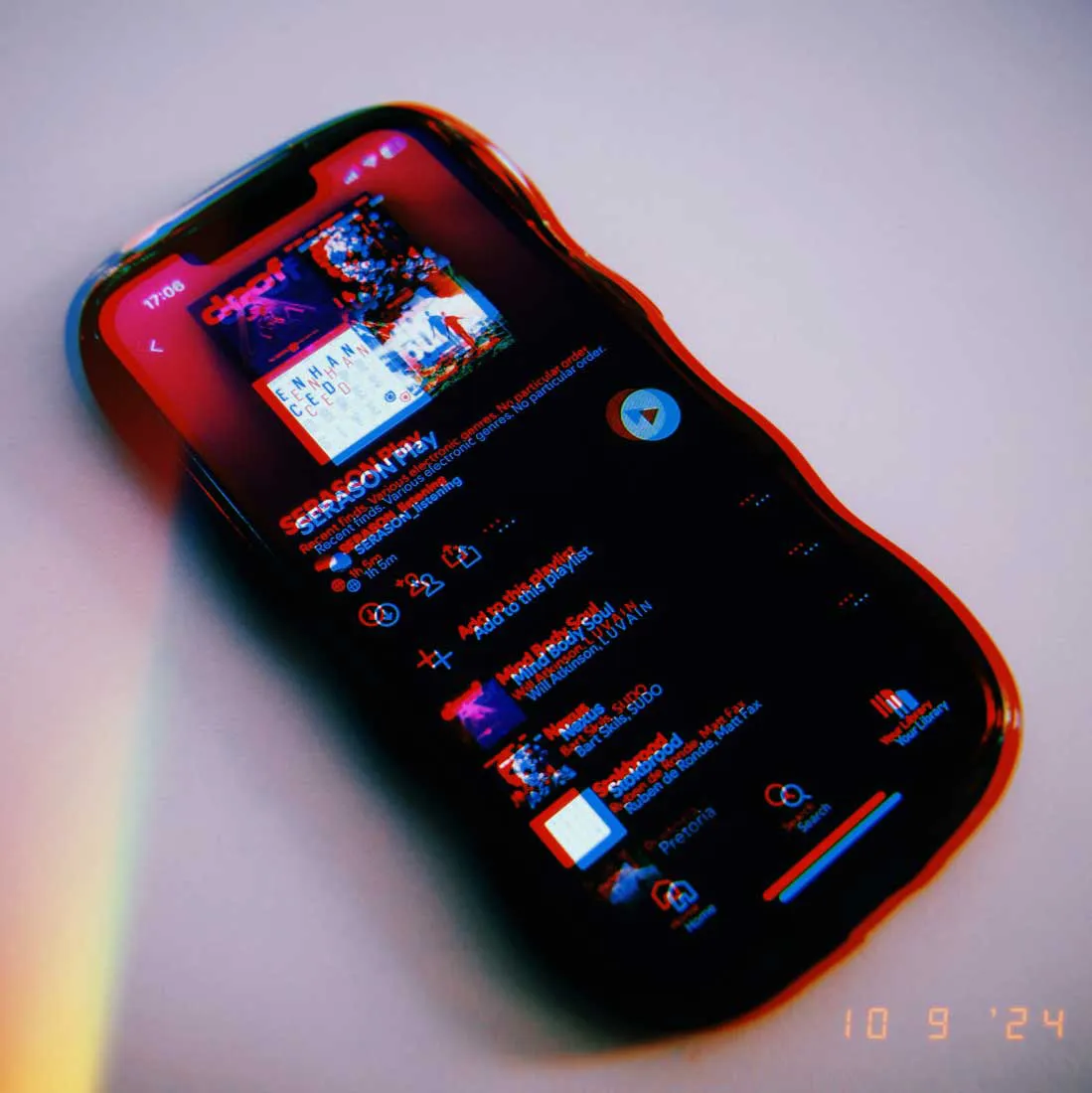 Photo of iPhone and Spotify app open on SERASON Play